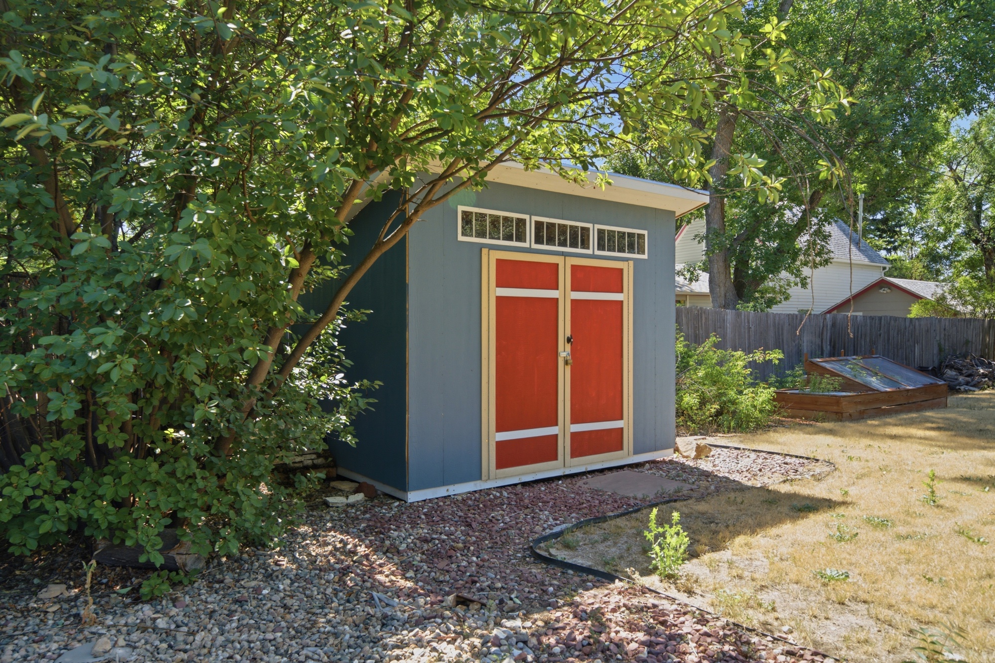 Charming backyard shed with red doors