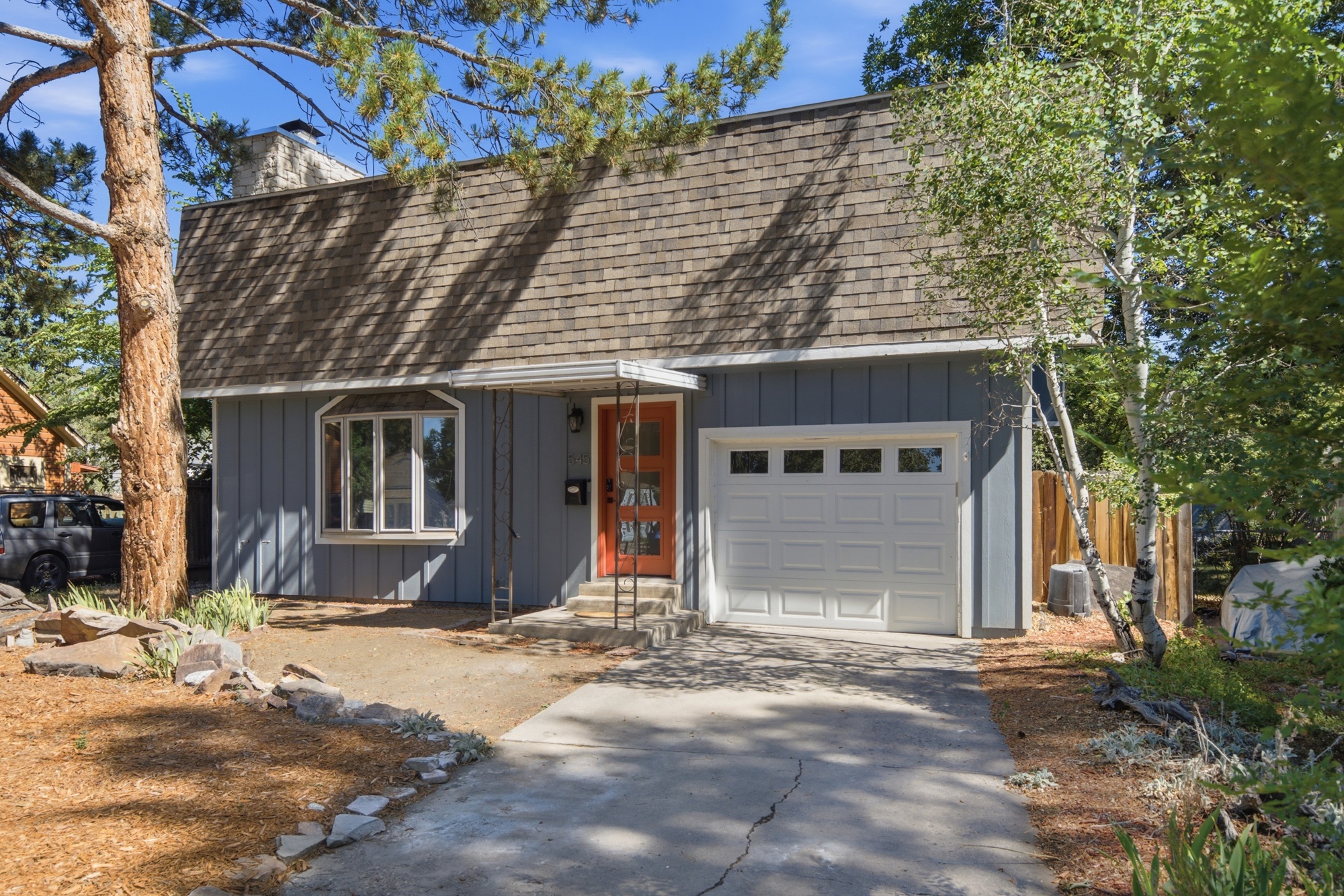 Front exterior with driveway and chimney